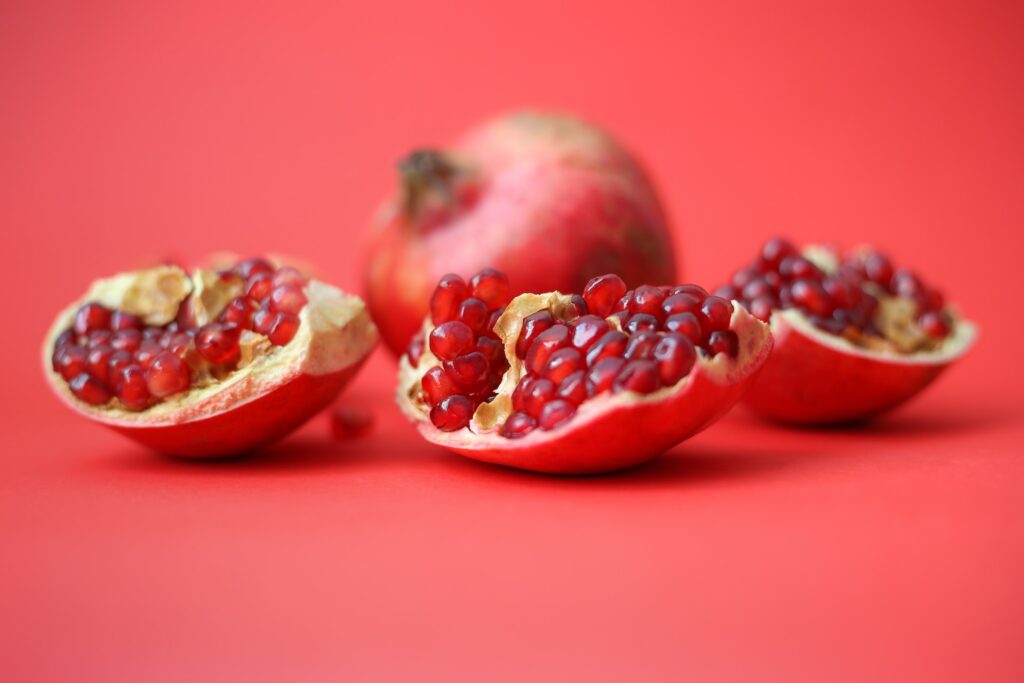 Pieces of a pomegranate on a red background